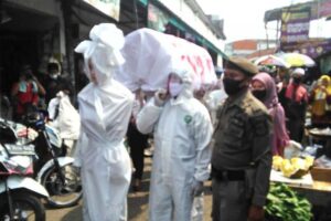 Ingatkan Warga Untuk Pakai Masker, Pocong dan Keranda Mayat Diarak Keliling Pasar